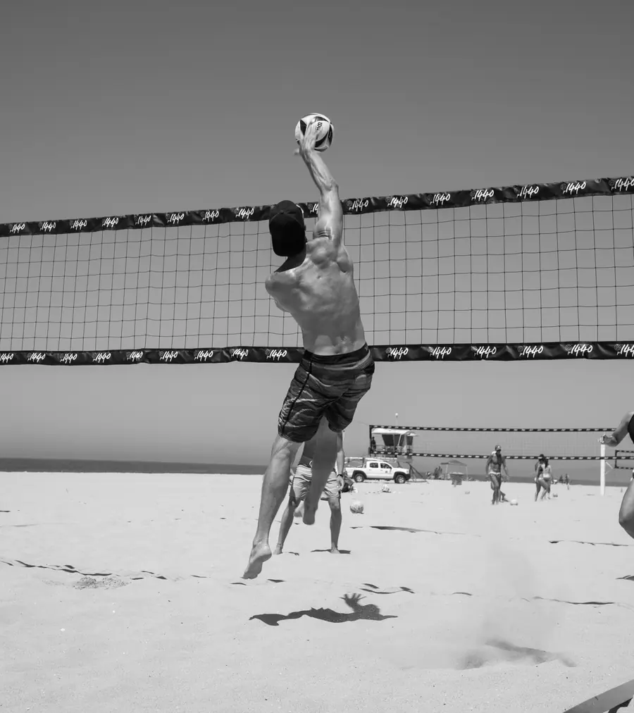 Player jumping to spike the ball over the net